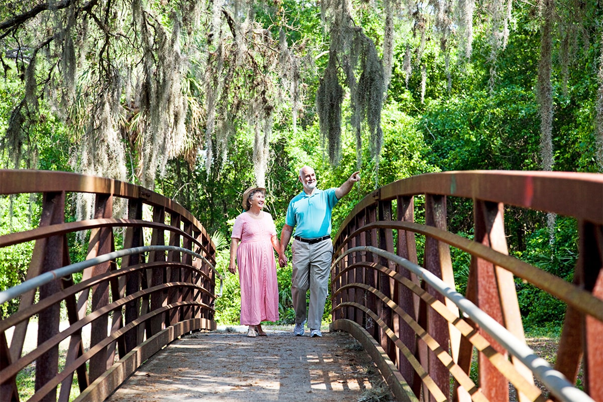 Edlerly couple walking on bridge in florida