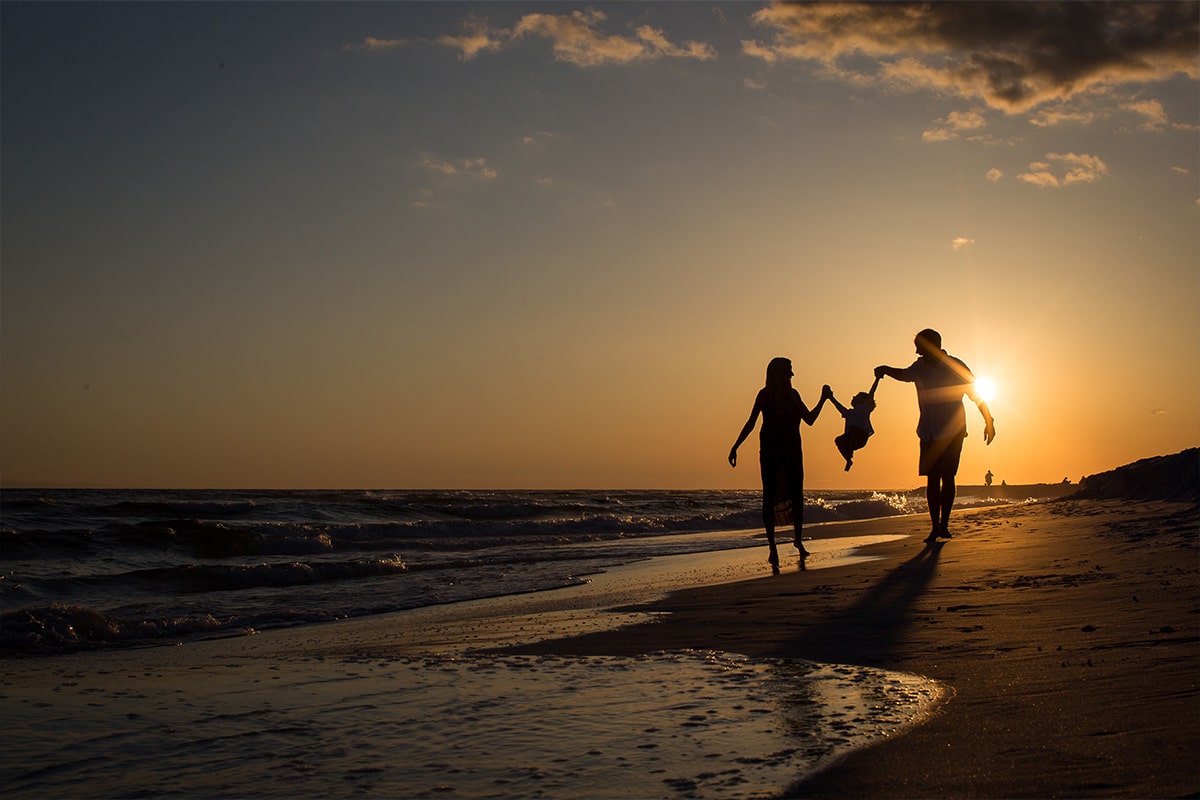 Family on beach during sunset