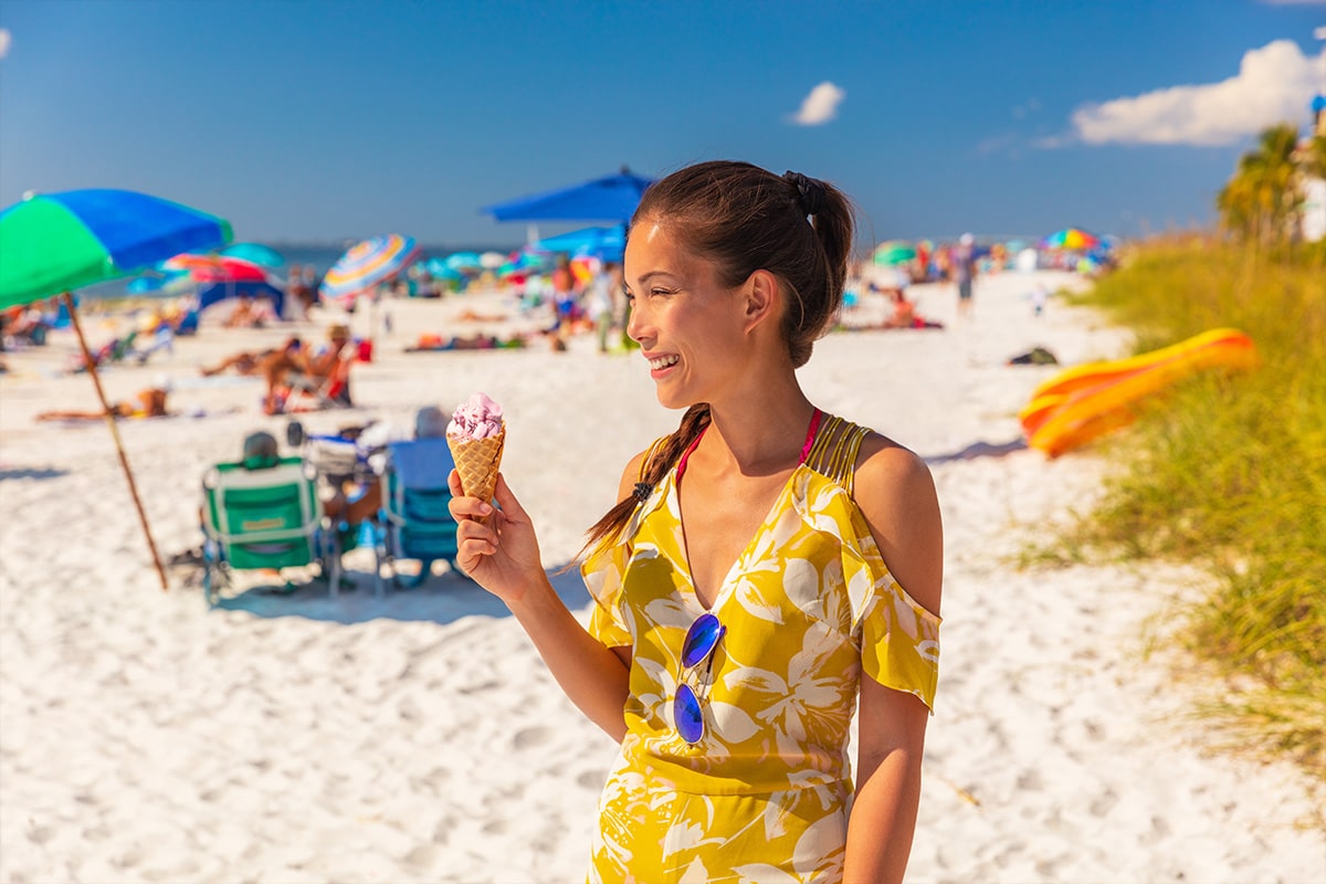 Woman holding ice cream on florida beach