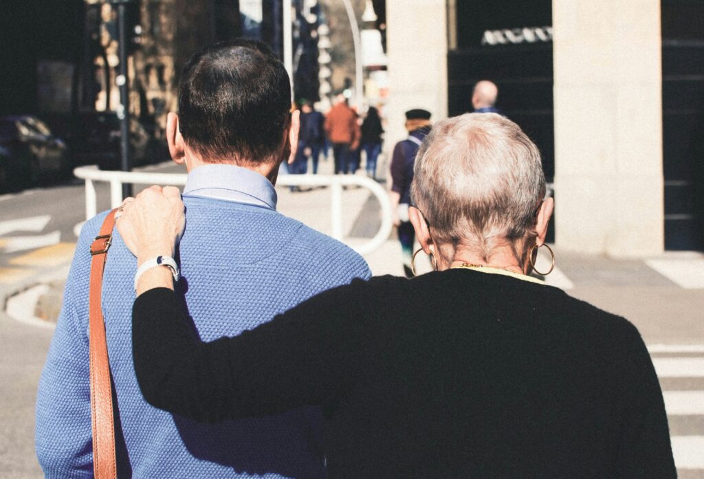 Older couple walking arm in arm