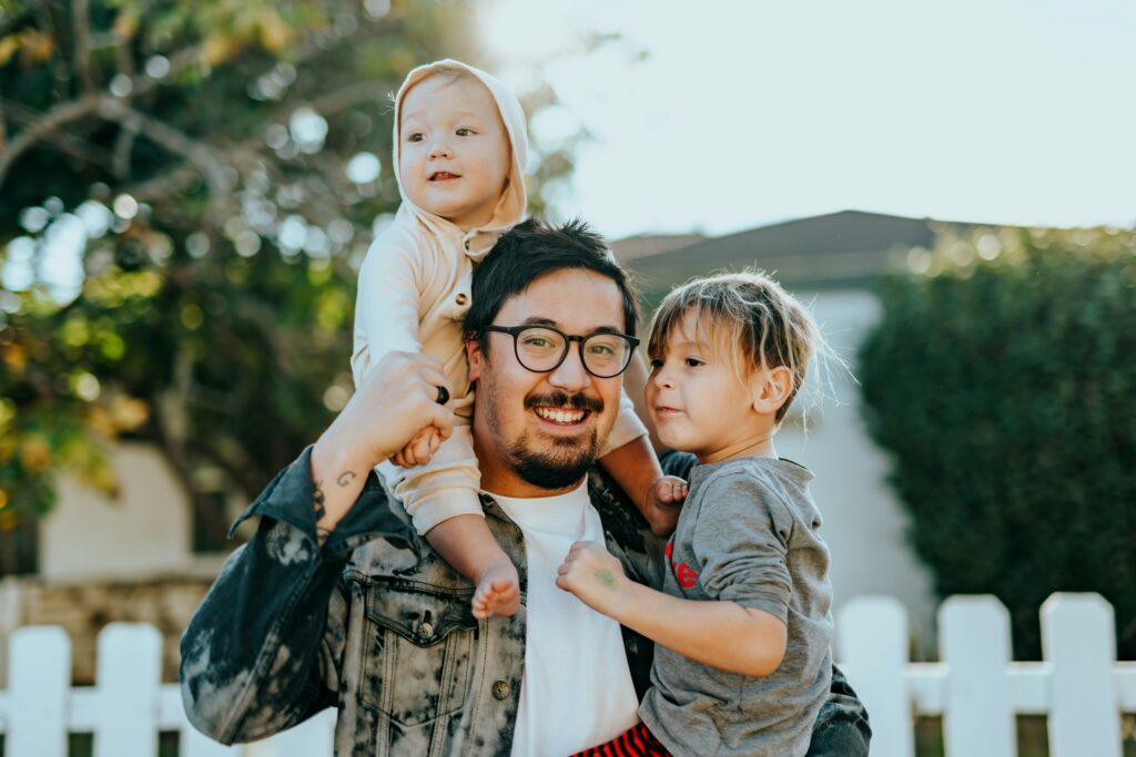 Florida father with young children enjoying time together, representing how group health insurance supports family health and security.