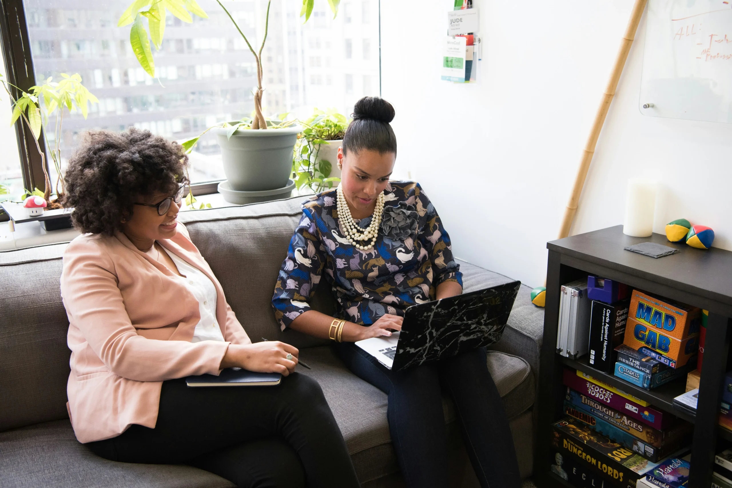 Two professionals reviewing Medicare coverage options on a laptop, illustrating Medigap eligibility and enrollment guidance for Florida residents.