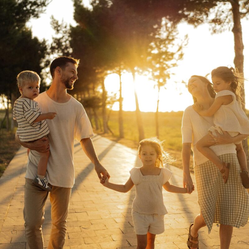 A Florida family walking together outdoors, representing how families explore Affordable Care Act health insurance options in Florida.