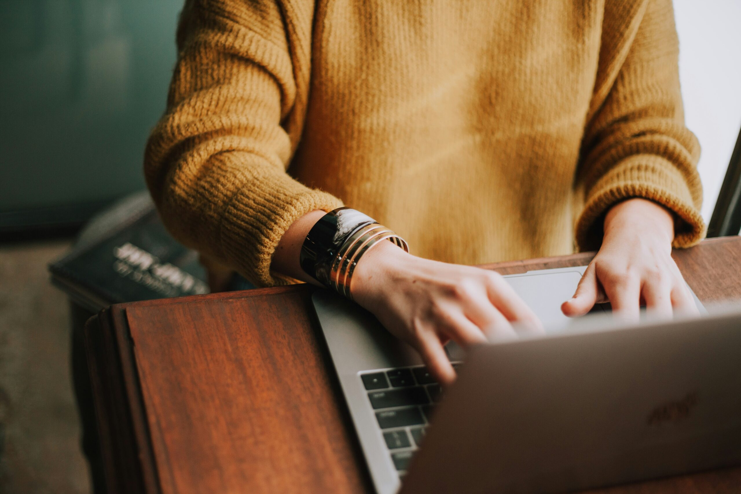 A person using a laptop to review plan details, representing how Florida small businesses compare group health insurance options.