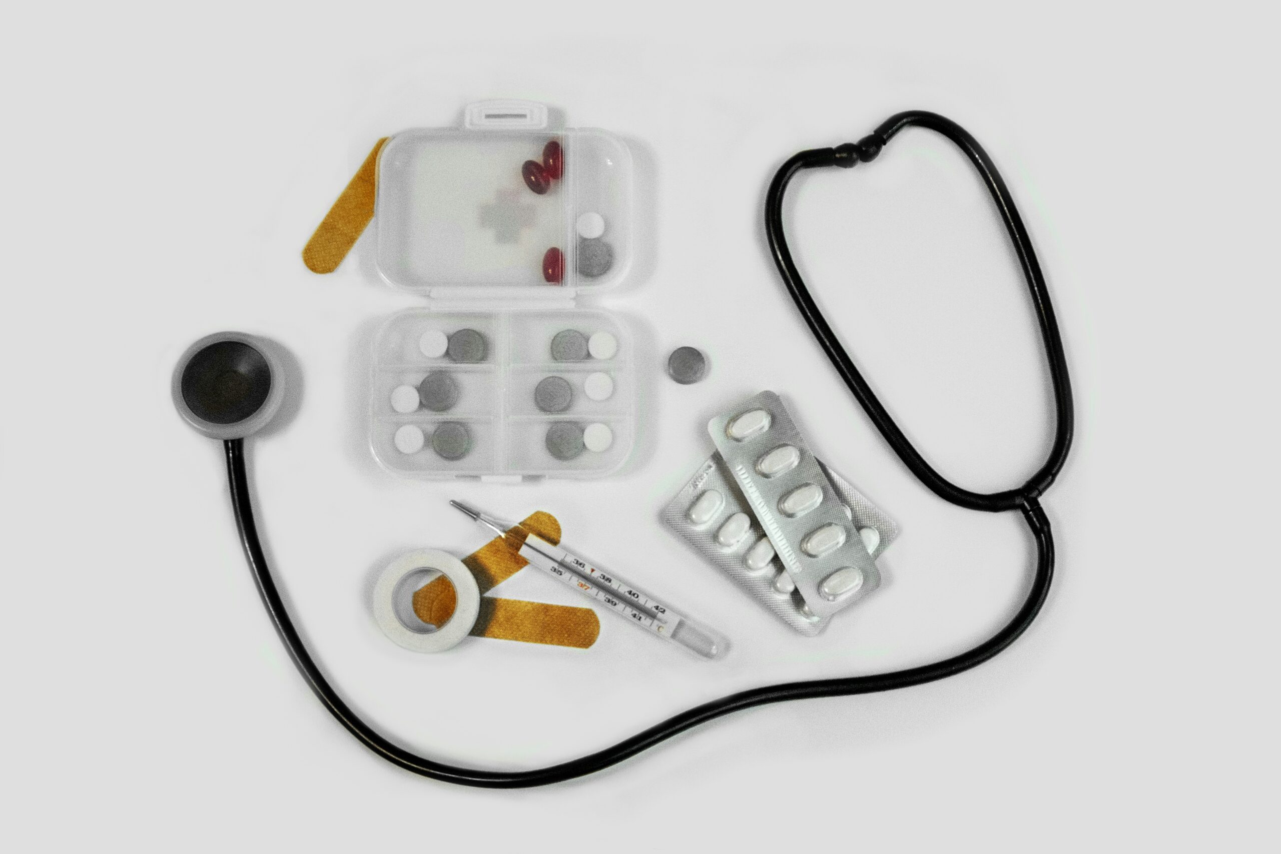 Prescription medications and medical tools arranged on a table, illustrating Medicare Part D prescription drug coverage options for Florida seniors.