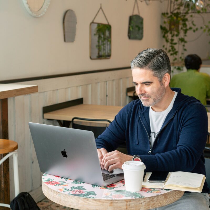 A professional reviewing information on a laptop
