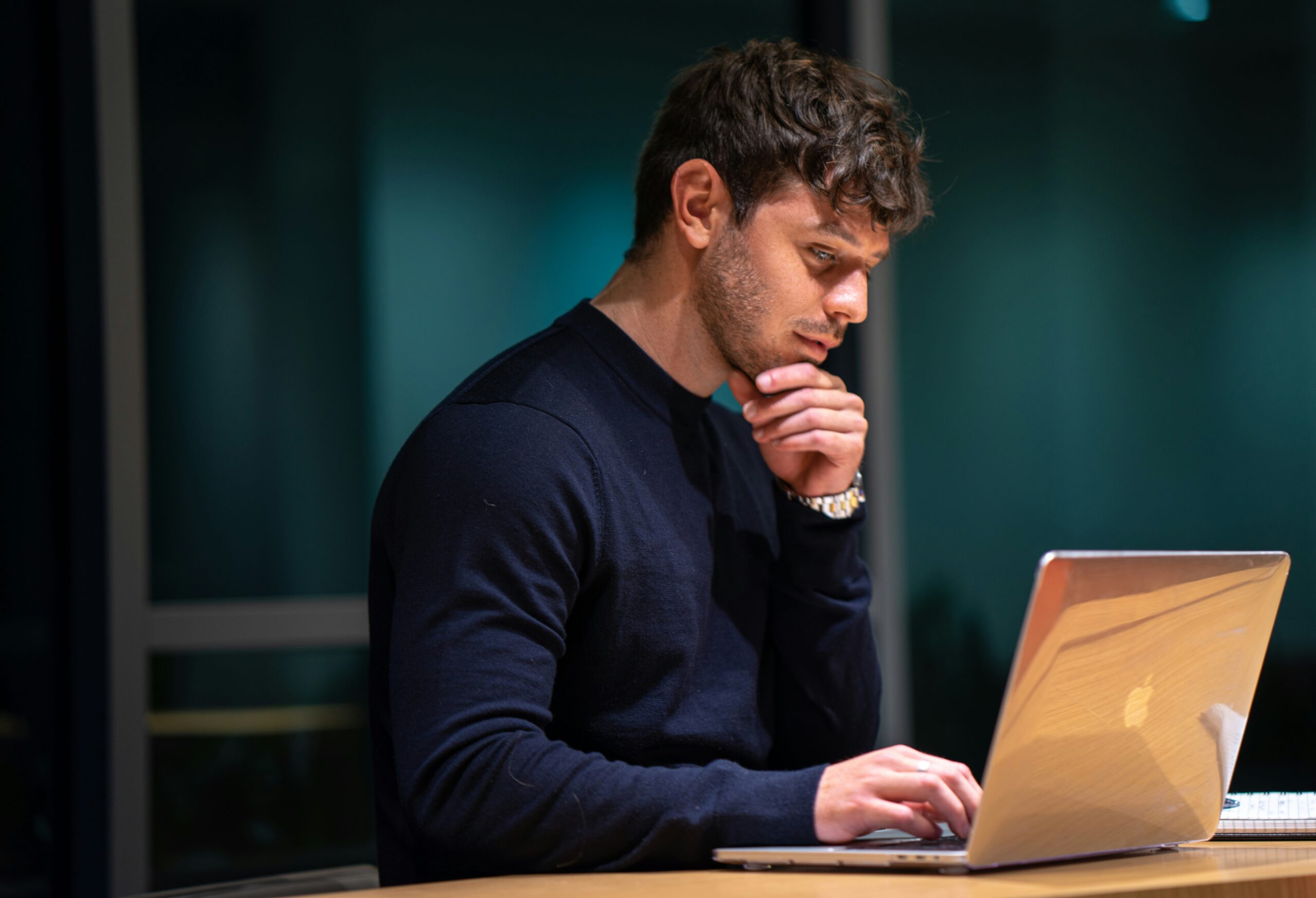 A Florida business owner reviewing enrollment details on a laptop, illustrating eligibility and enrollment requirements for group health insurance plans.