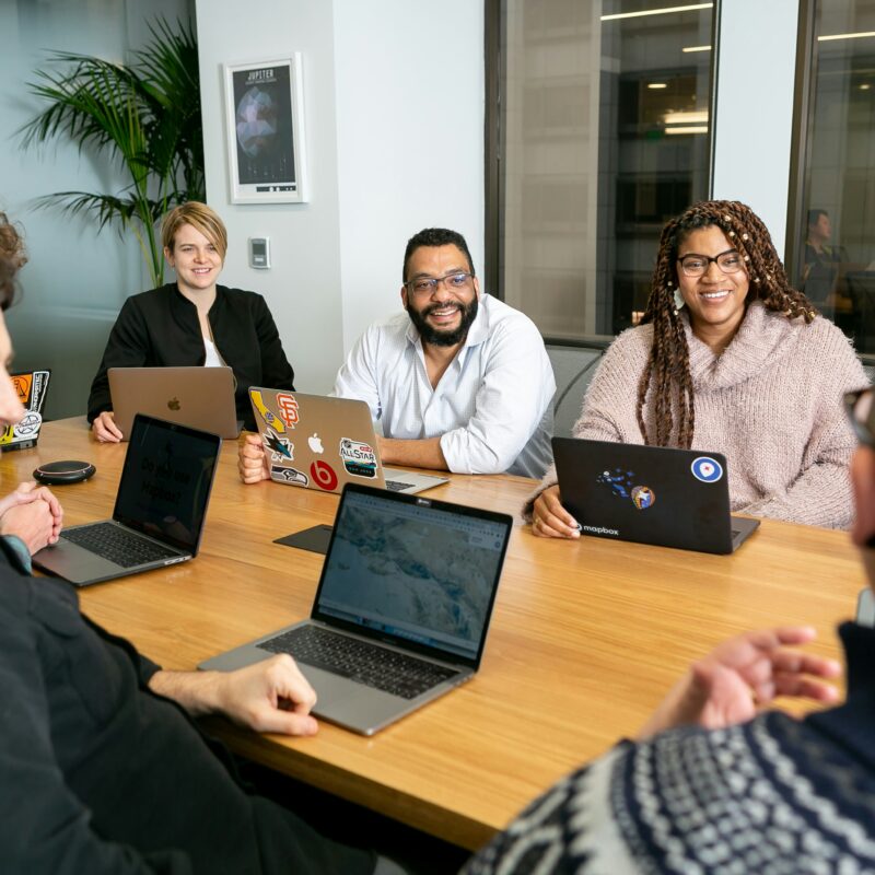 Business professionals collaborating in a meeting, discussing health insurance plans that help empower Florida small businesses.