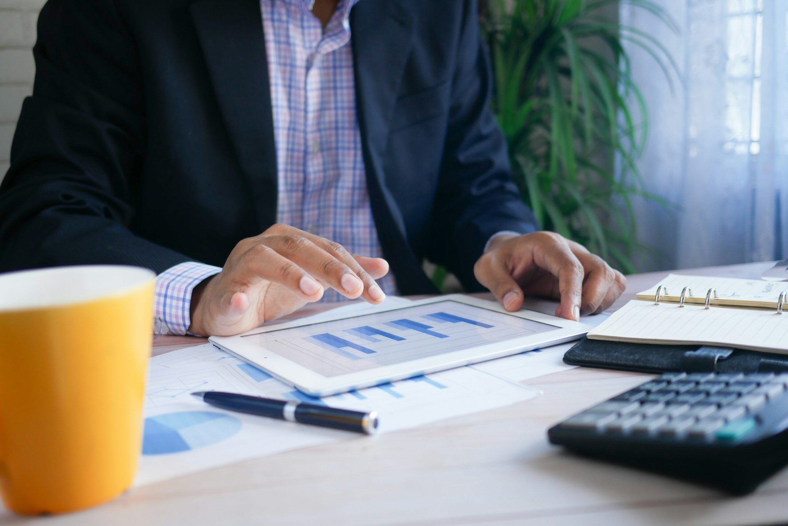 A business owner reviewing financial charts on a tablet, showing how Florida small businesses manage health insurance costs and maximize savings.