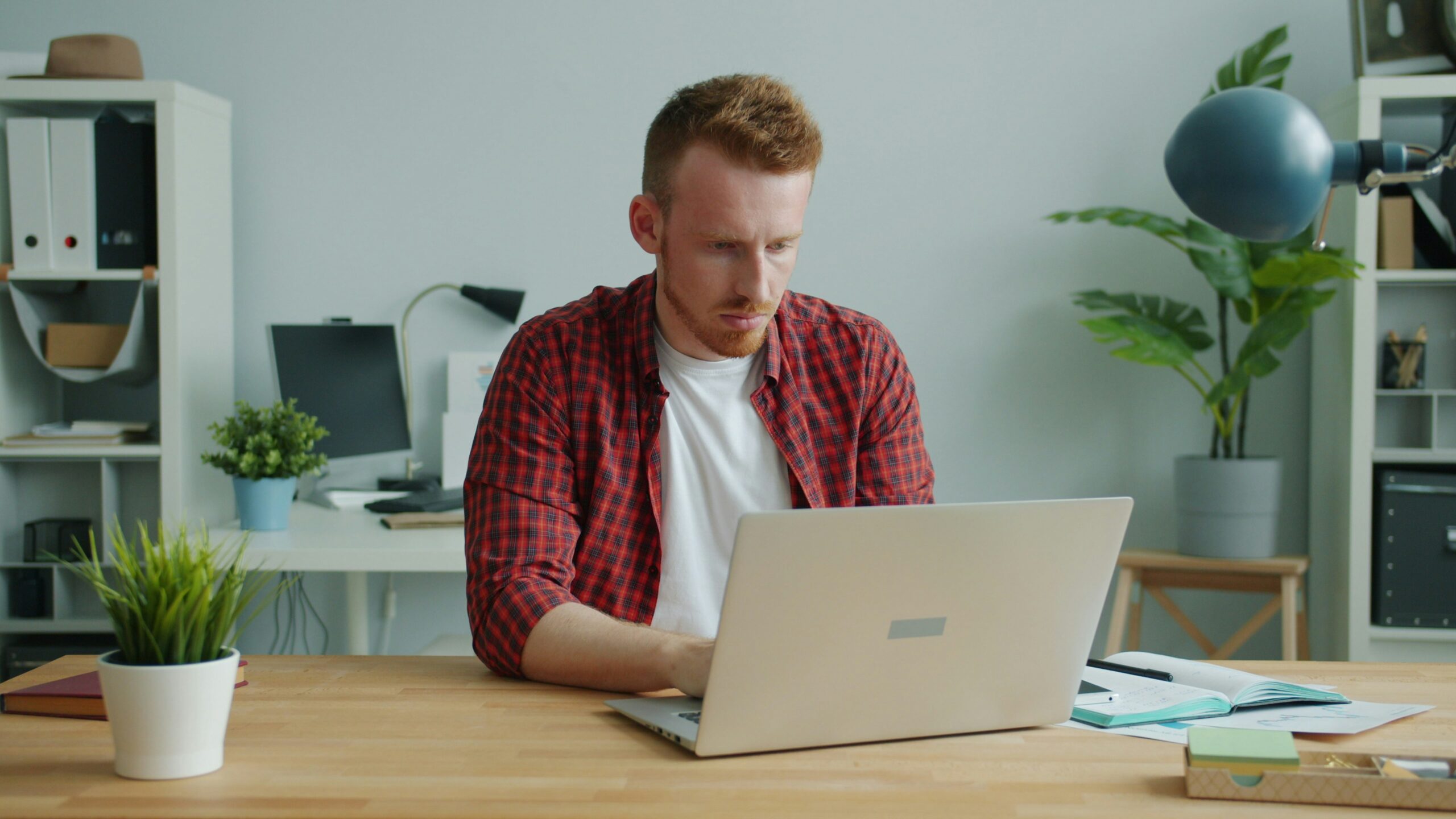 Florida small business owner reviewing compliance and regulatory requirements on a laptop in a home office.