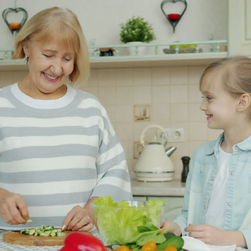 A Florida grandmother and child preparing a healthy meal together, symbolizing how age and family stages influence health insurance costs in Florida