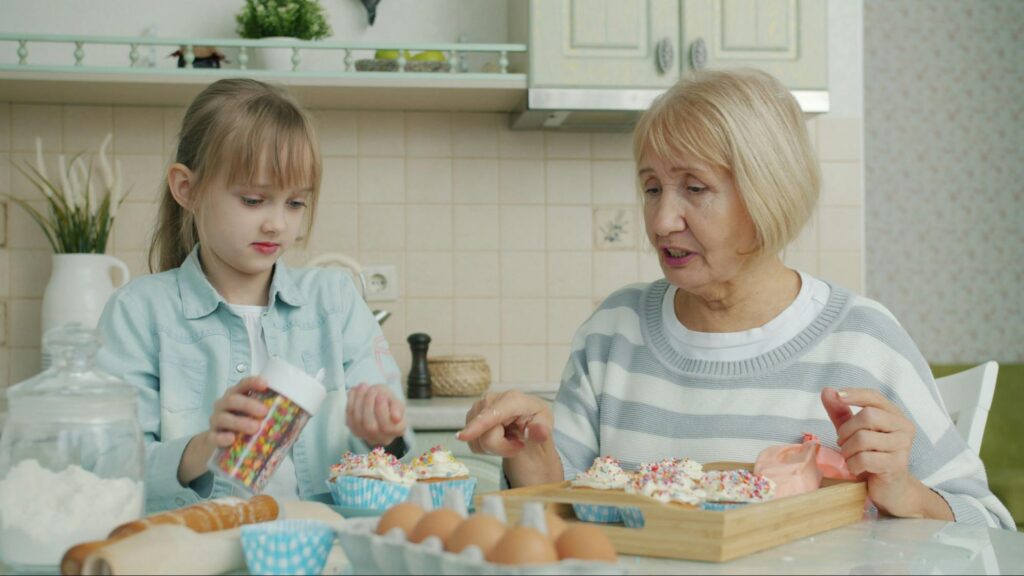 Grandparent and child baking together, representing the unique healthcare and coverage considerations for both children and seniors.