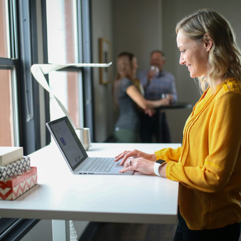 Professional reviewing ACA-enhanced private health insurance options in Florida on a laptop in a modern workspace.