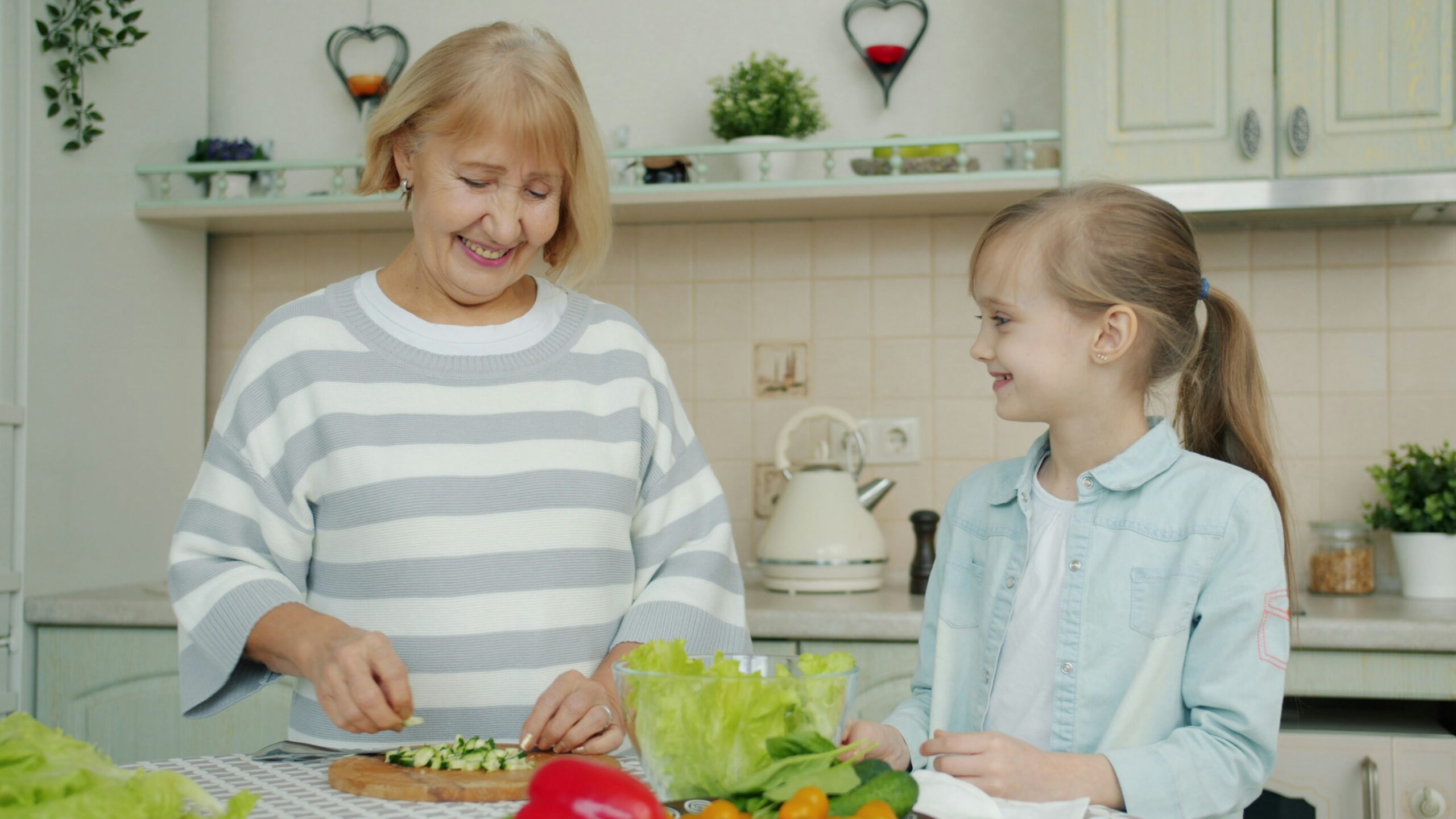 Grandmother and child preparing a healthy meal together, representing Florida family health insurance plans that support all generations.