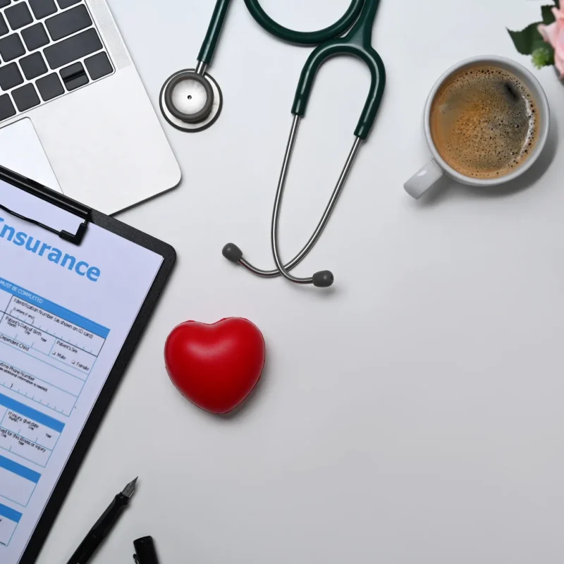 Health insurance application form with medical tools symbolizing how Florida residents can find their ideal private health insurance plan today.