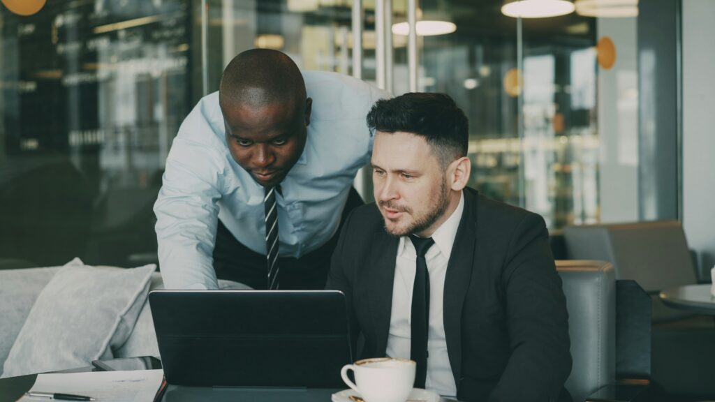 Two professionals reviewing a Florida health insurance plan on a laptop, analyzing how coverage gaps can affect policyholders’ costs and care access