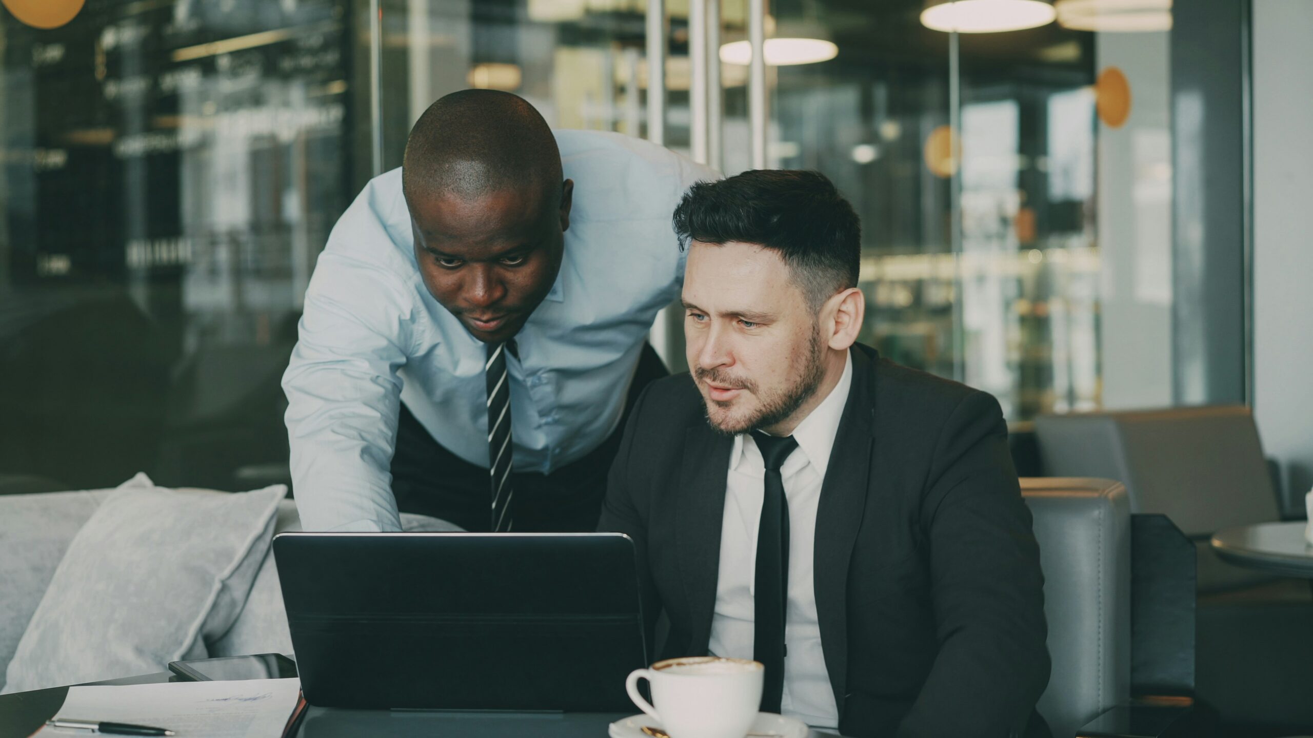 Two professionals reviewing a Florida health insurance plan on a laptop, analyzing how coverage gaps can affect policyholders&rsquo; costs and care access