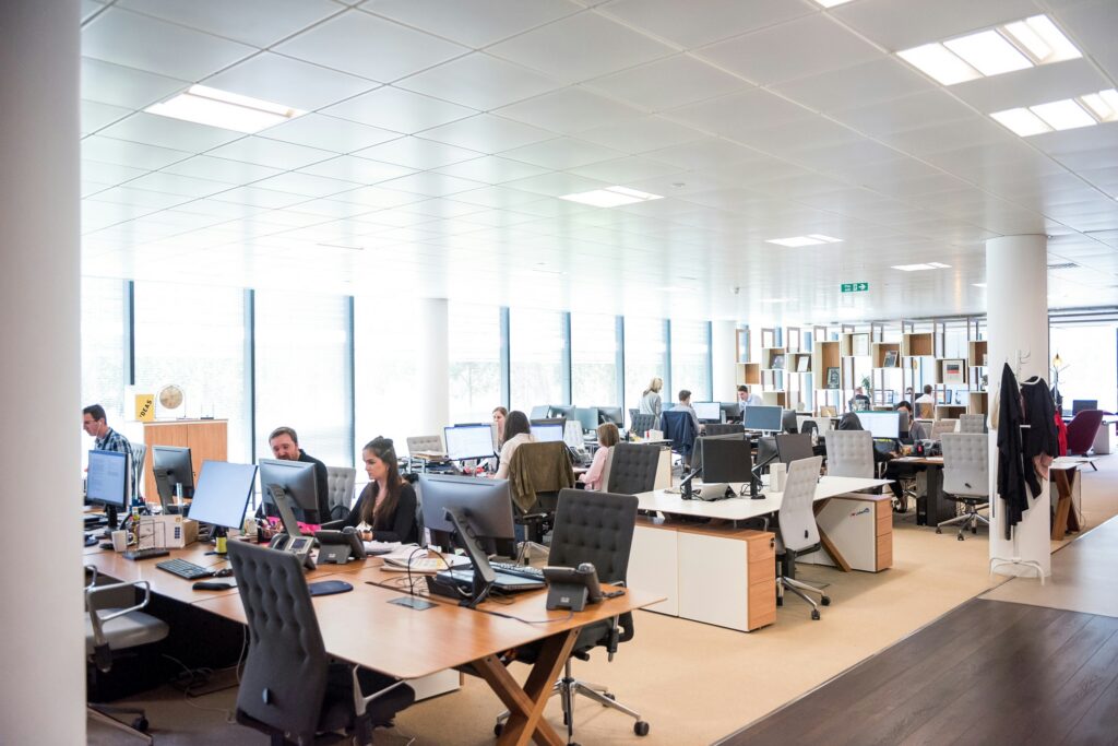 Employees working in a modern office environment representing businesses that use small group health insurance plans to provide team healthcare coverage.