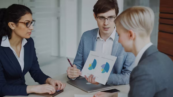 Insurance consultant reviewing small group health insurance documents to help businesses make informed and strategic coverage decisions.