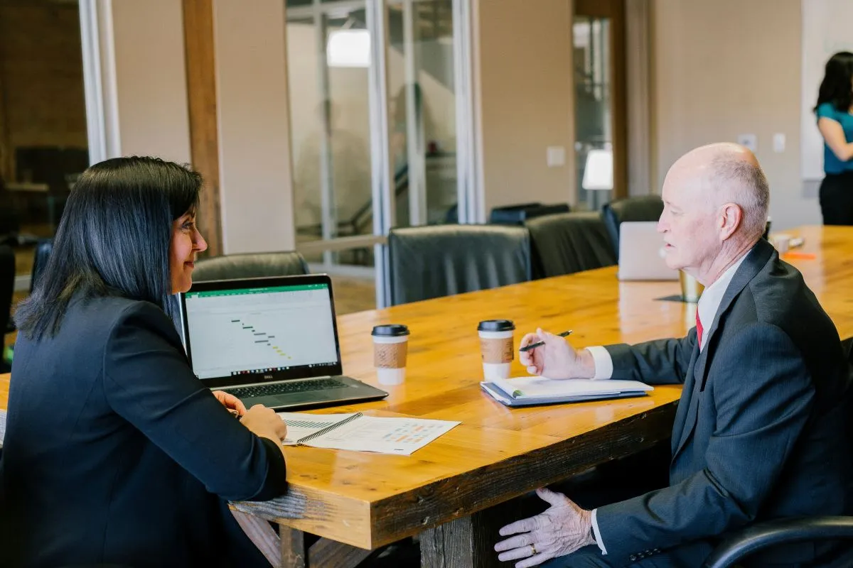Employer and benefits advisor reviewing group health insurance costs and renewal options | ProCare Consulting Employer and benefits advisor reviewing group health insurance costs and renewal options