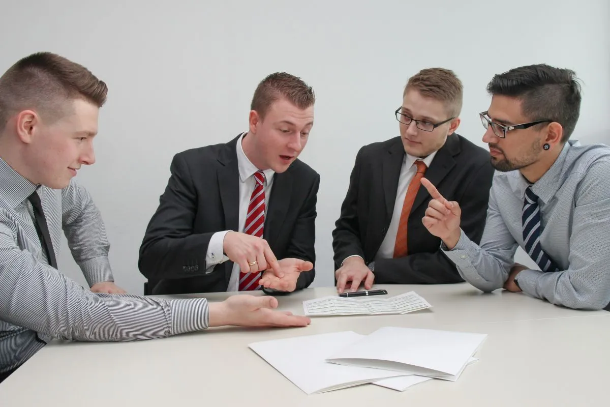 Small business team reviewing payroll records and employee health benefits information