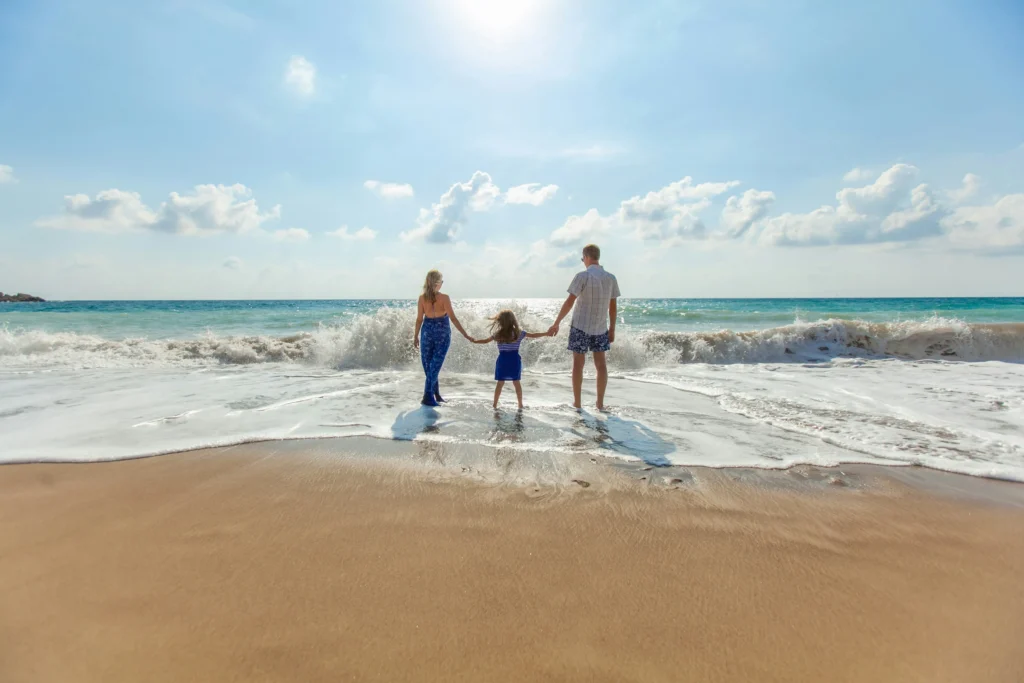 Family walking together along the shoreline