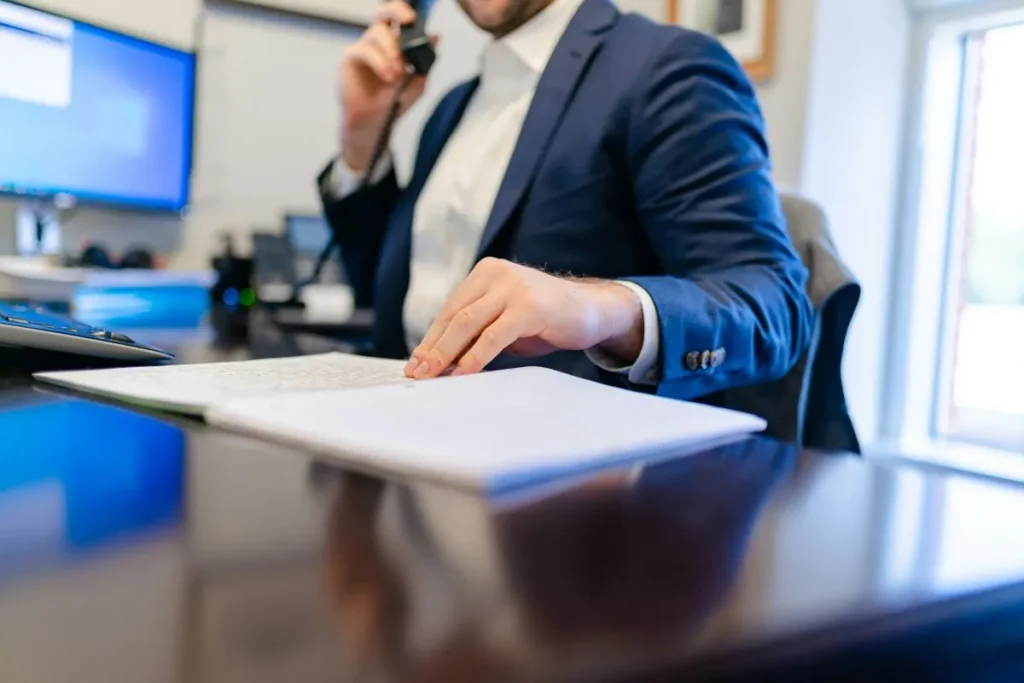 Man reviewing paperwork at an office desk