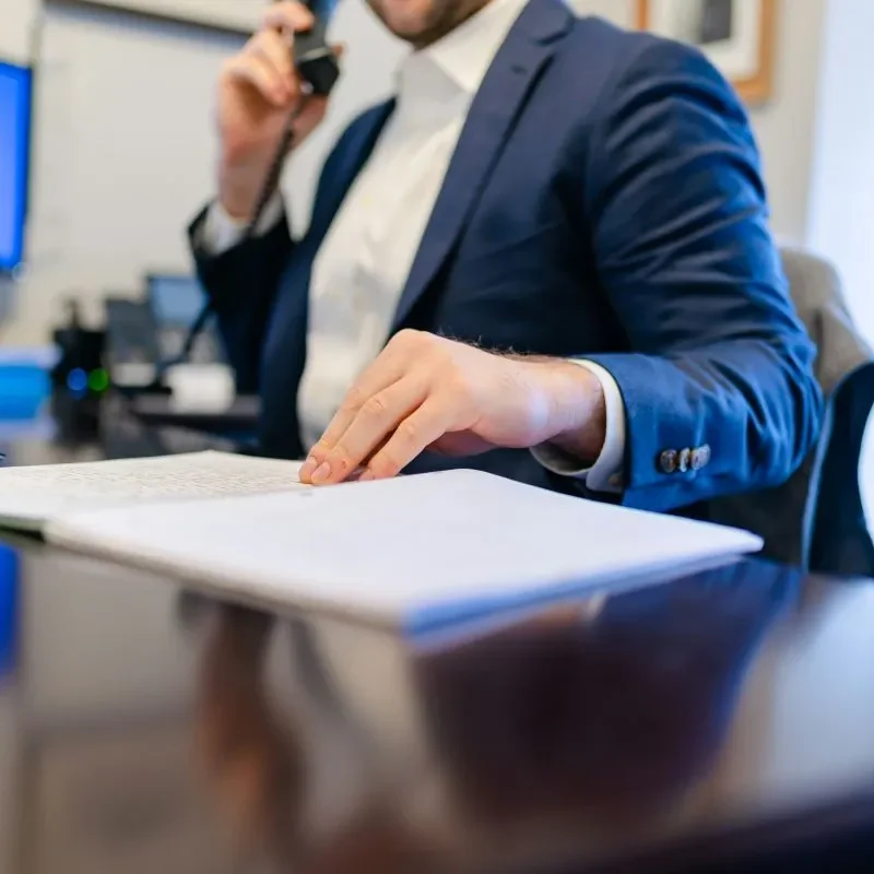 Man reviewing paperwork at an office desk
