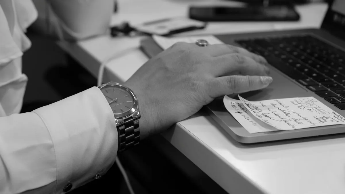 Person reviewing prescription information beside a laptop | ProCare Consulting Person reviewing prescription information beside a laptop