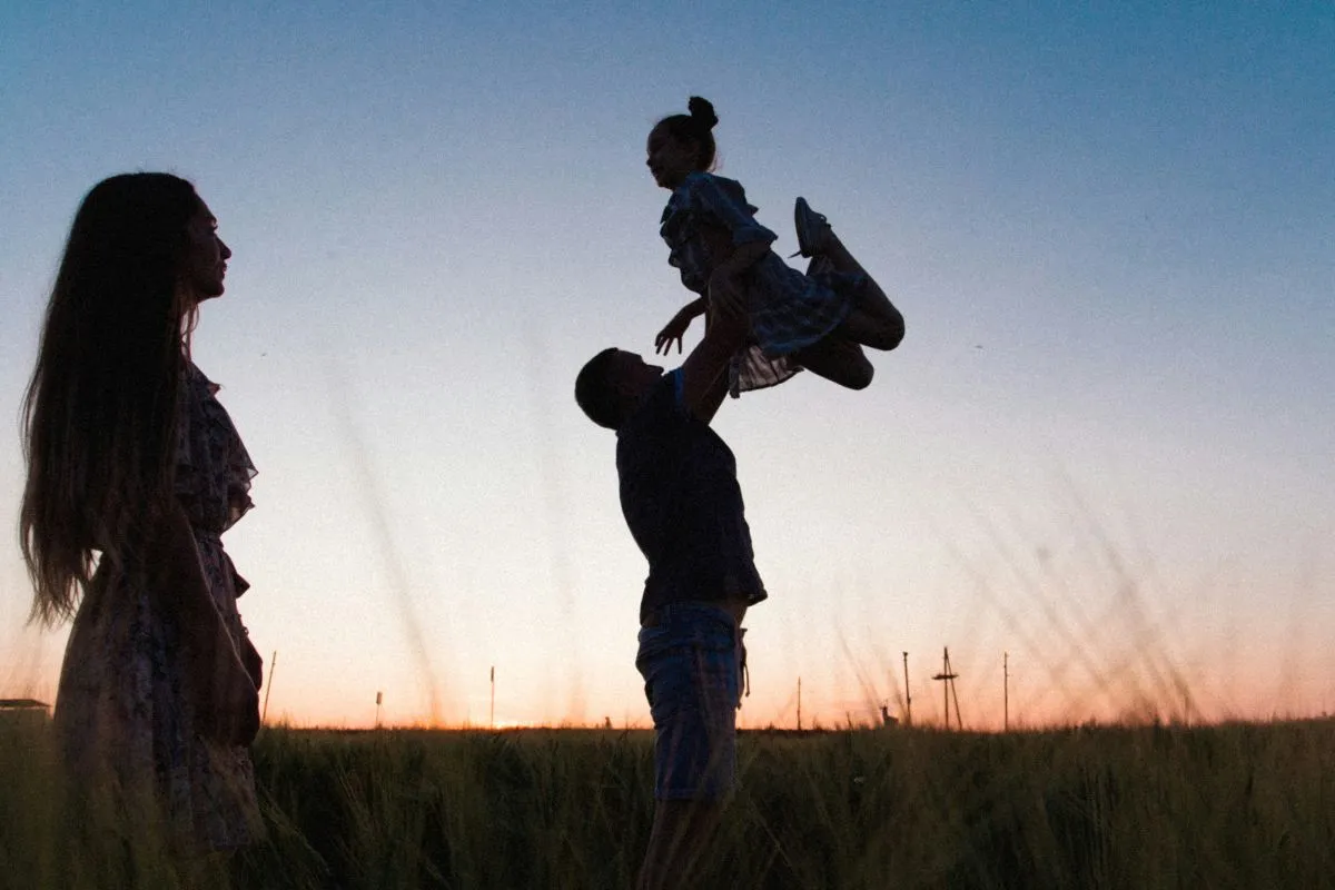 Family spending time together outdoors at sunset