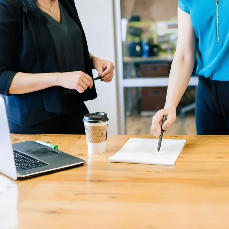 Two people reviewing prescription coverage information