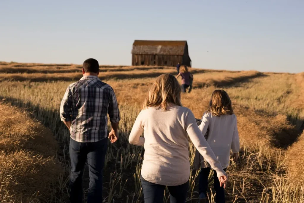 Family walking together through an open field
