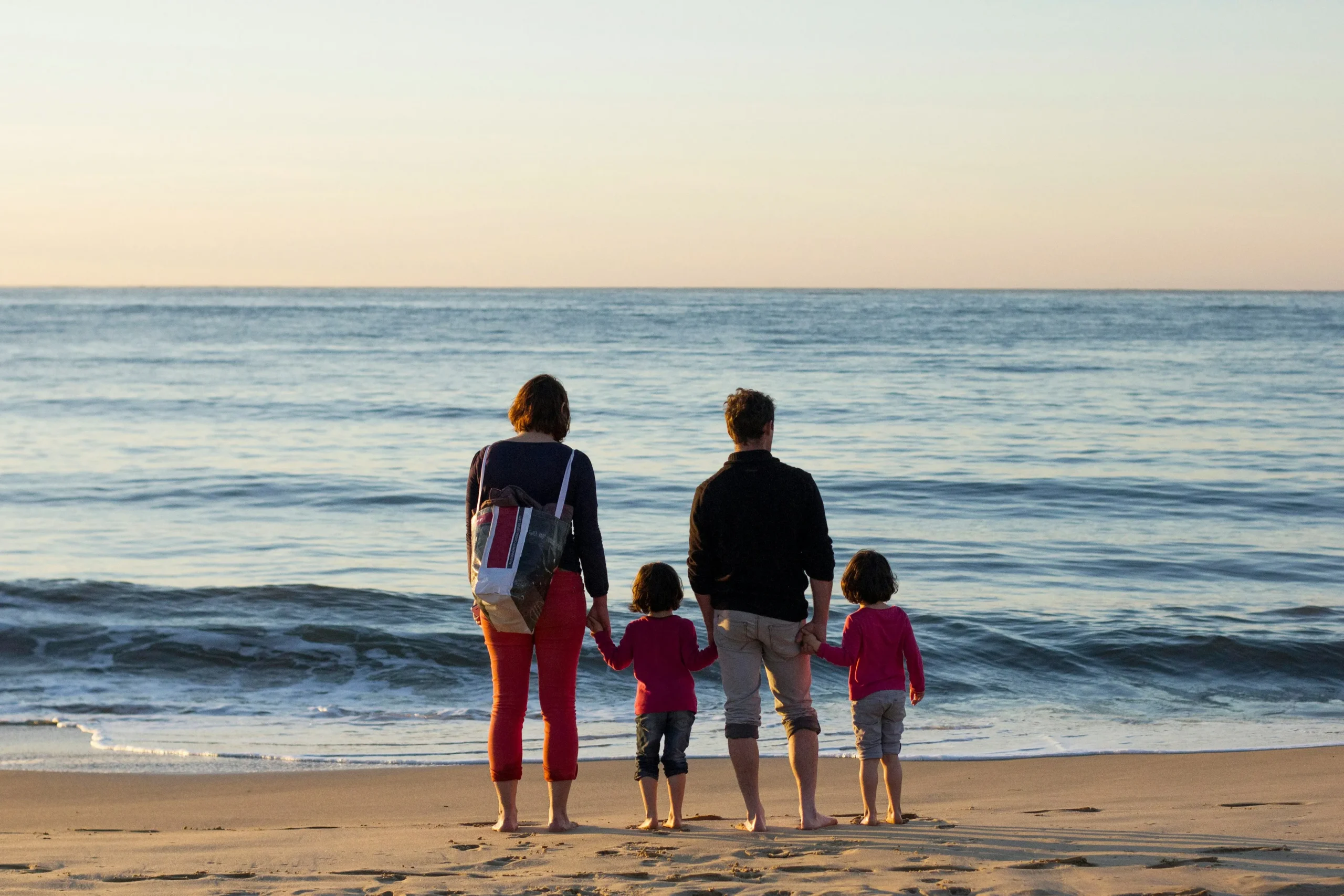 Family standing together on a beach